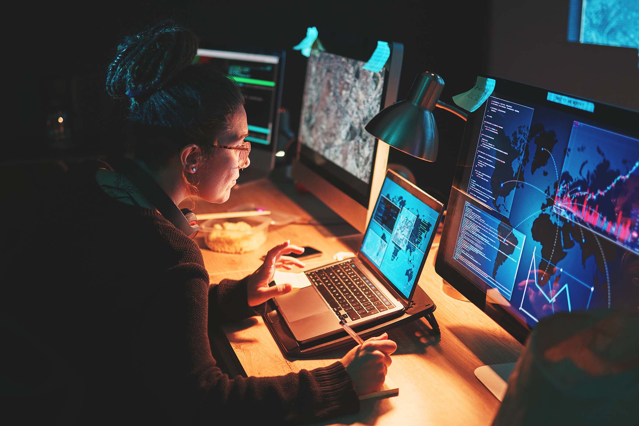 cybersecurity-woman-and-computer-with-global-info-PQ5XGET.jpg